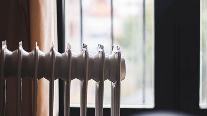 An electric heater in front of a window