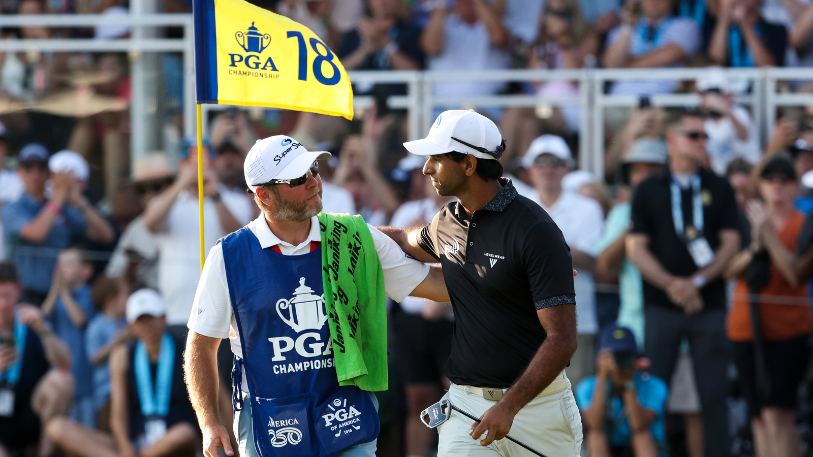 Aaron Rai and his caddie walk off the 18th green at the PGA Championship