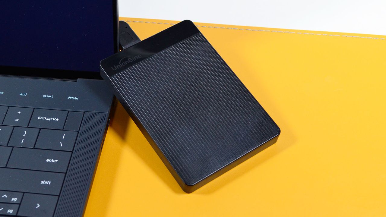 A UnionSine Ultra Slim external HDD on a desk with a laptop