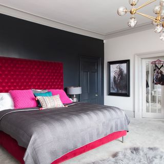 bedroom with charcoal feature wall and pedant lights