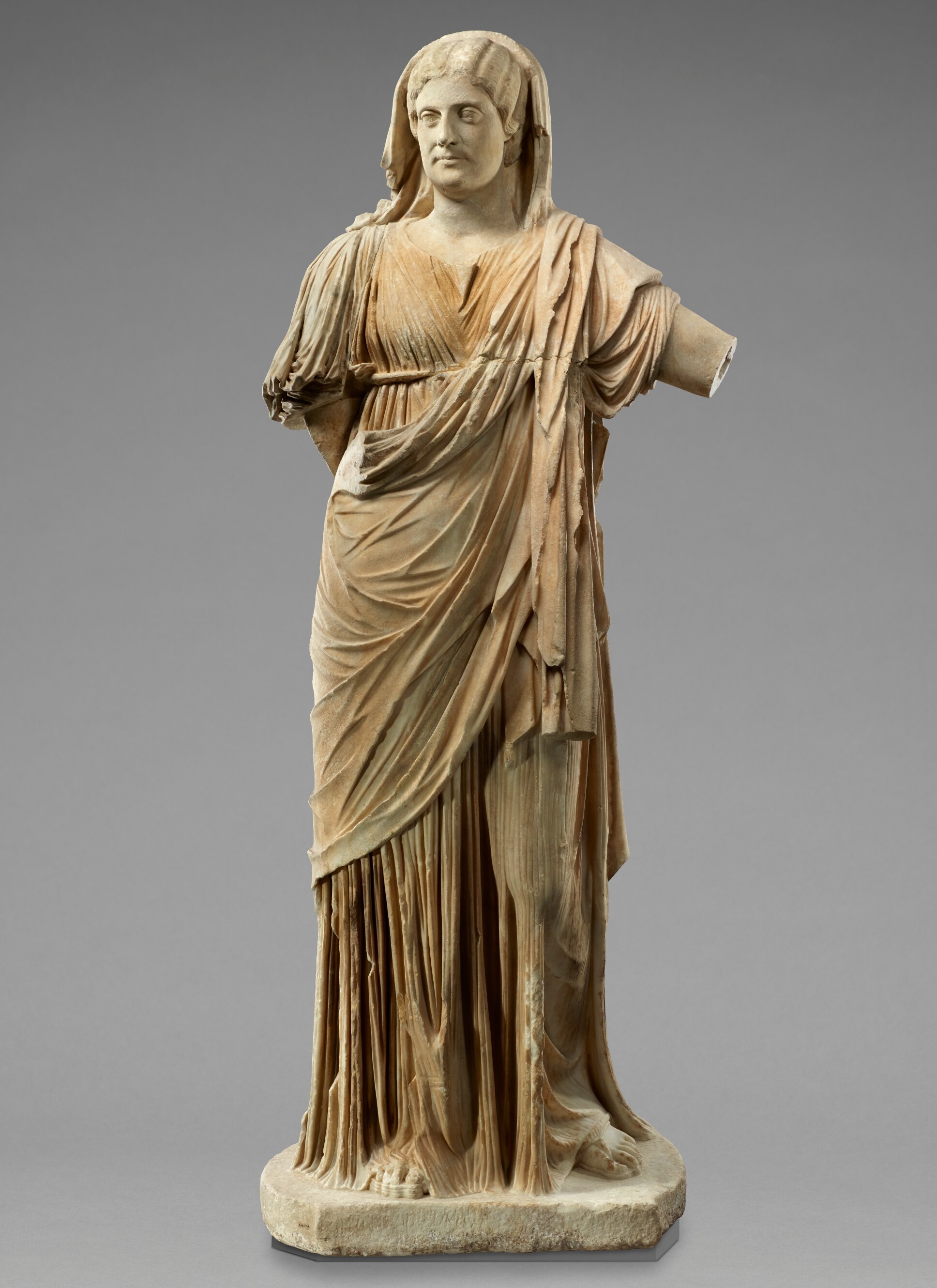 A statue of a woman wearing a draped dress