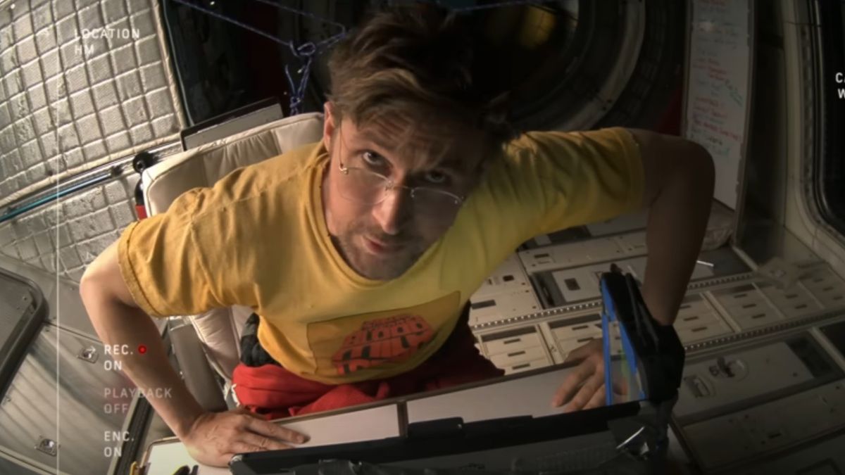 Ryland talking into a video camera and looking up.