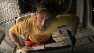 Ryland talking into a video camera and looking up.