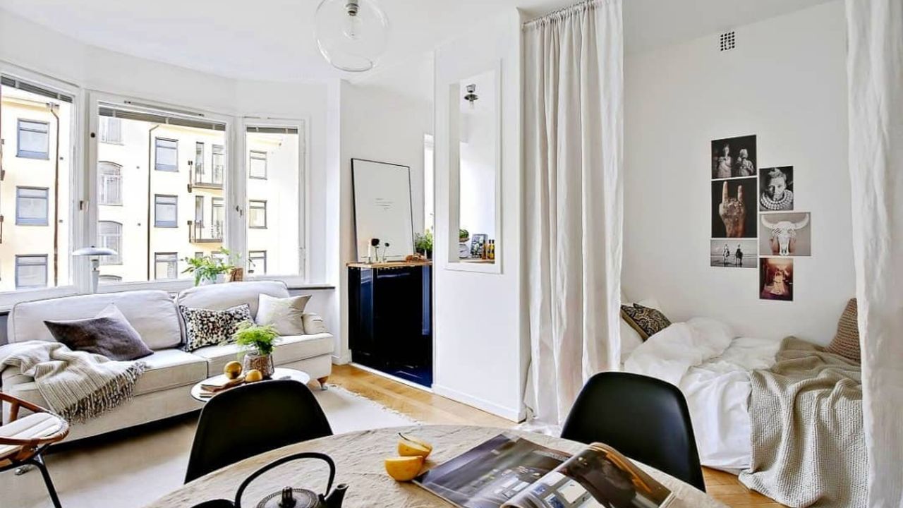 White studio apartment with long curtains