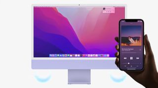 A mock-up of someone holding an iPhone and AirPlaying music to an iMac