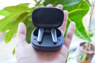 A photo of the EarFun Air Pro 3 open in their case in hand