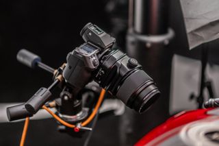 The Fujifilm GFX100 II on a tripod in a studio