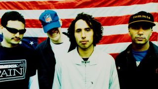 Rage Against The Machine in May 1996, standing in front of an inverted American flag