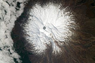 An astronaut photograph of Mount Ruapehu taken on Sept. 23, 2021. The highly acidic hydrothermal lake, known as Crater Lake, can be seen at the summit of the active stratovolcano. 