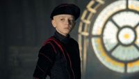 Dexter Sol Ansell as Egg standing in front of a stain glass window in A Knight of the Seven Kingdoms