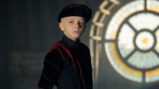 Dexter Sol Ansell as Egg standing in front of a stain glass window in A Knight of the Seven Kingdoms