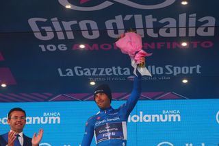 Groupama FDJs French rider Thibaut Pinot celebrates his best climbers blue jersey on the podium after the nineteenth stage of the Giro dItalia 2023 cycling race 183 km between Longarone and Tre Cime di Lavaredo rifugio Auronzo on May 26 2023 Photo by Luca Bettini AFP Photo by LUCA BETTINIAFP via Getty Images