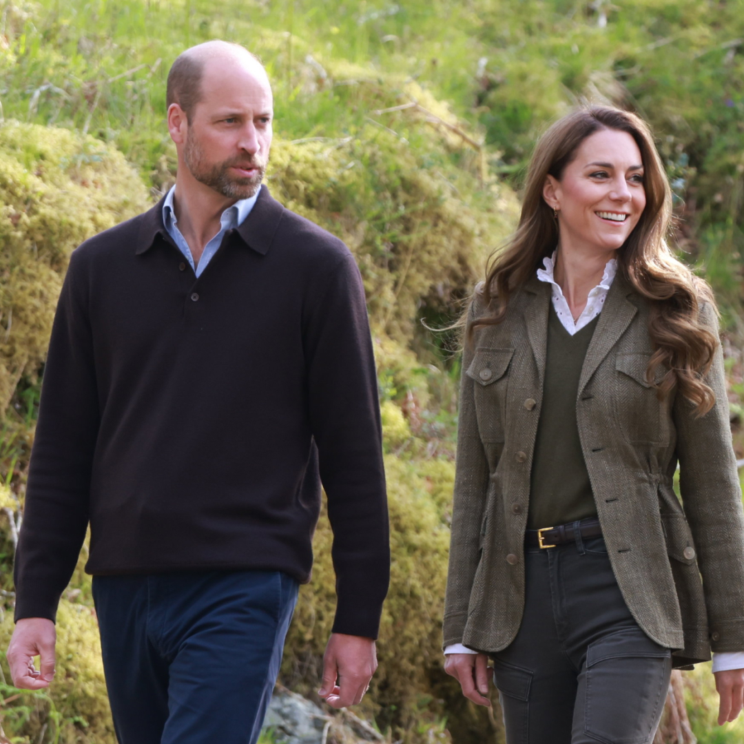 Prince William and Princess Kate walking together in nature.