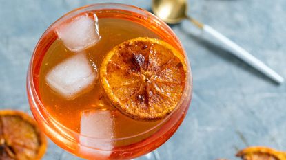 cocktail with dried orange slices - stock photo