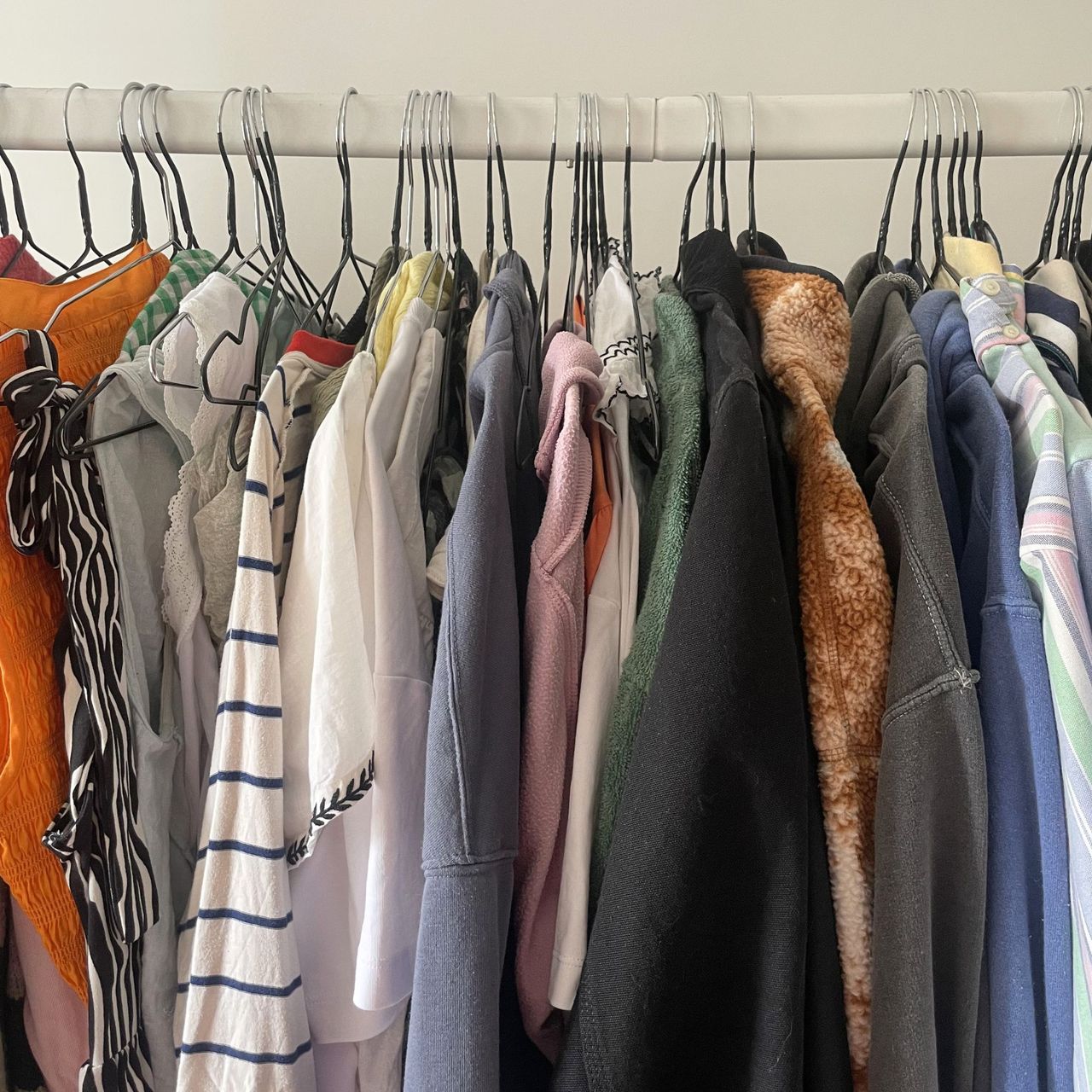 Hanging clothes rail with clothes hanging from it
