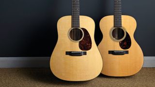 Two Martin guitars against a wall