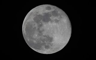 The last Blue Moon of 2018 is seen over Oval Road, in Millburn, New Jersey, on March 31, 2018. It is the first full moon of spring.