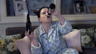Susie drinking beer in bed in The Marvelous Mrs. Maisel