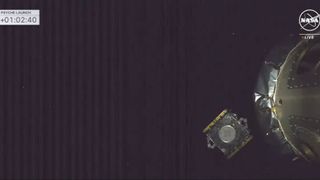 a cube-shaped spacecraft deploys from a rocket's upper stage with the blackness of space in the background.
