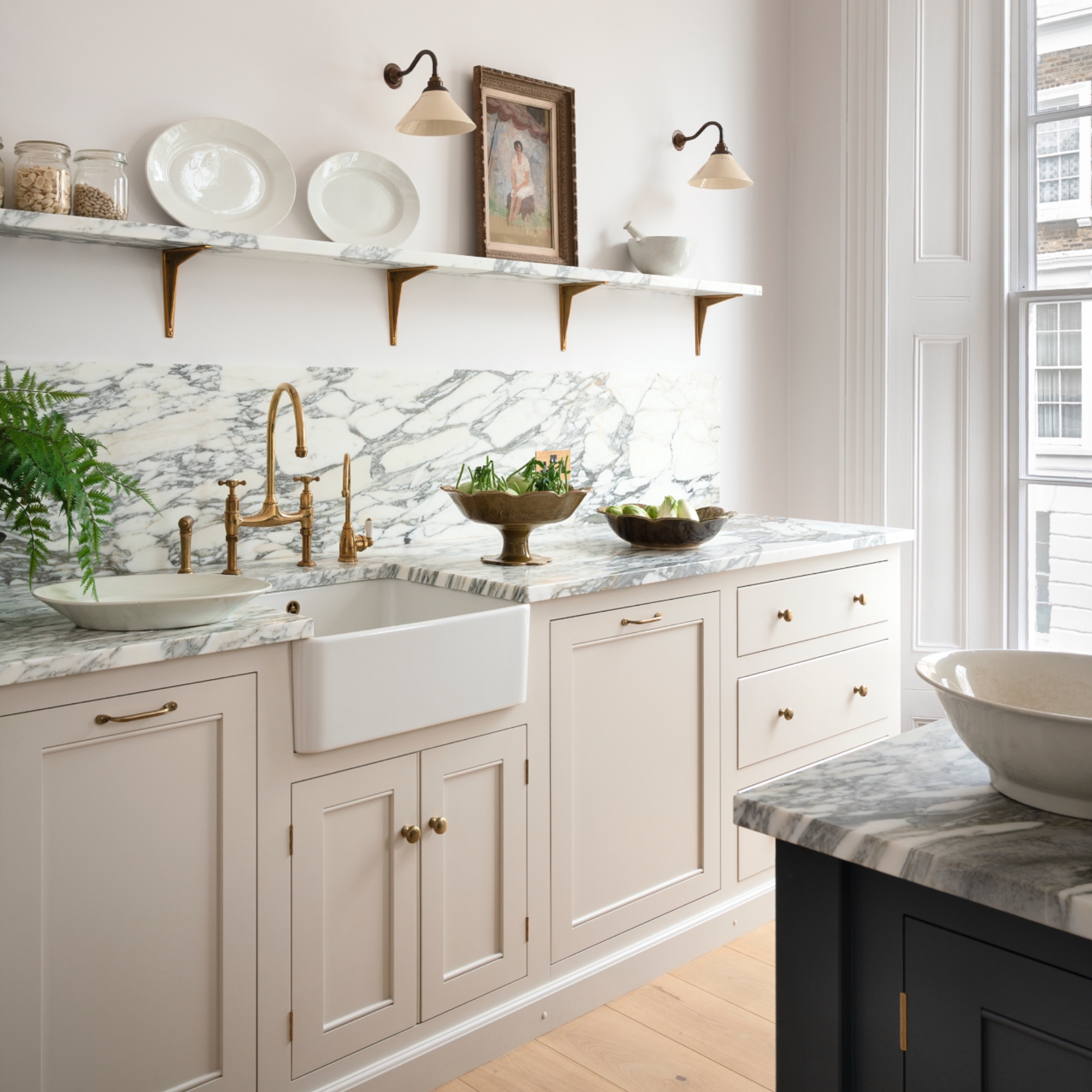marble and white kitchen with cream units, marble work tops, open shelving
