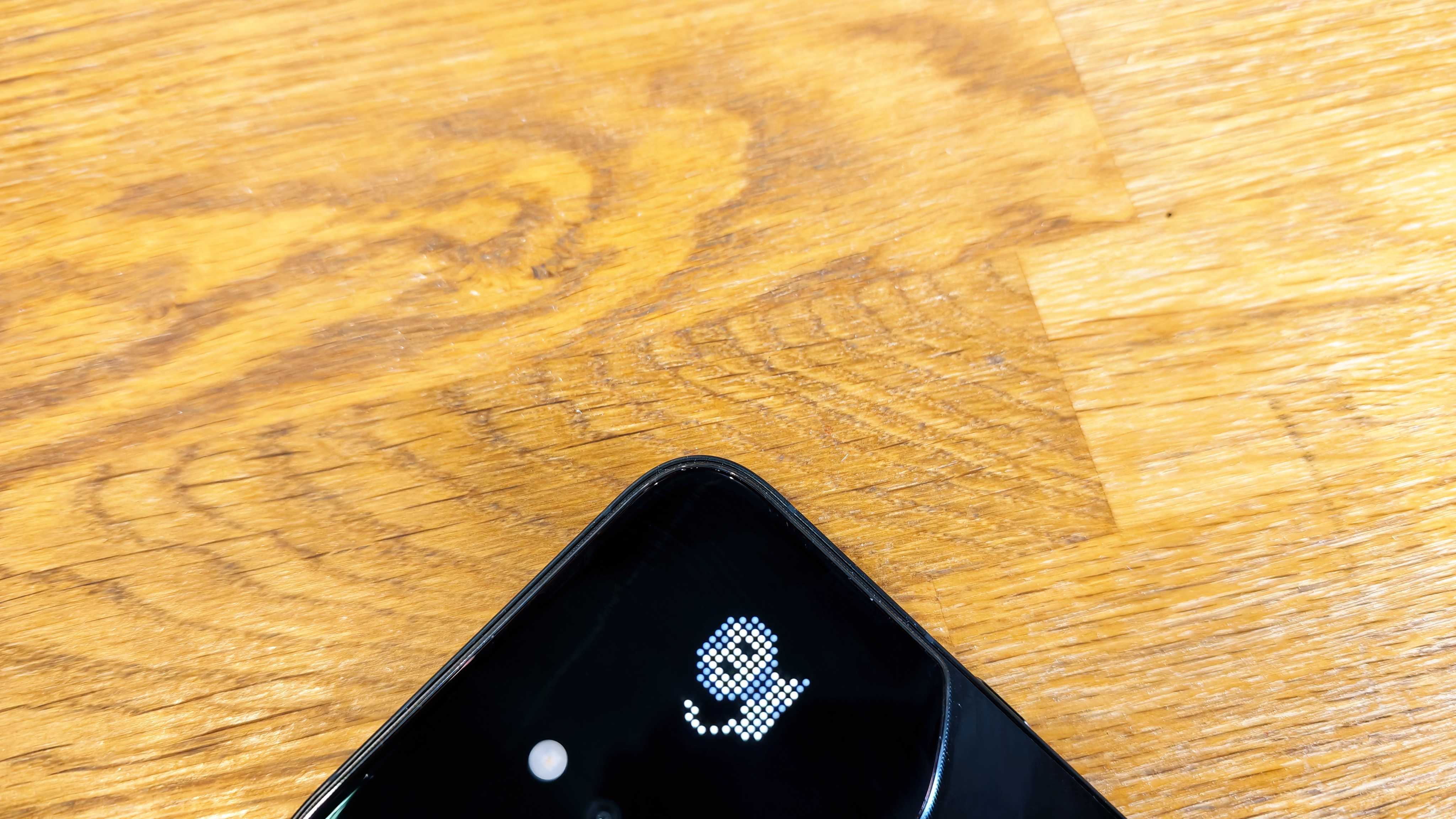 Image of the Infinix Note 60 Ultra sitting on a wooden table