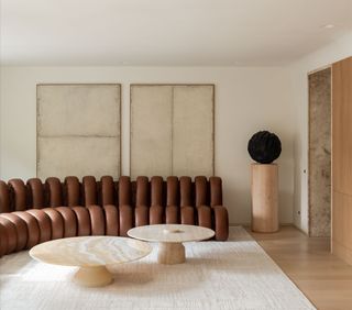 a minimalist living room with a brown leather couch