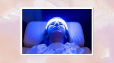 Woman lying down with LED face mask on