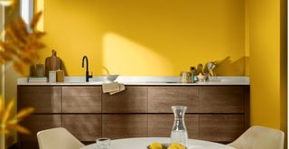 Sunshine yellow kitchen with wooden handleless cabinets