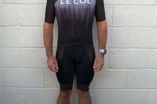 Image shows a rider wearing the Le Col Pro Indoor Bib Shorts.