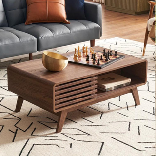 A dark wood coffee table with a chess set