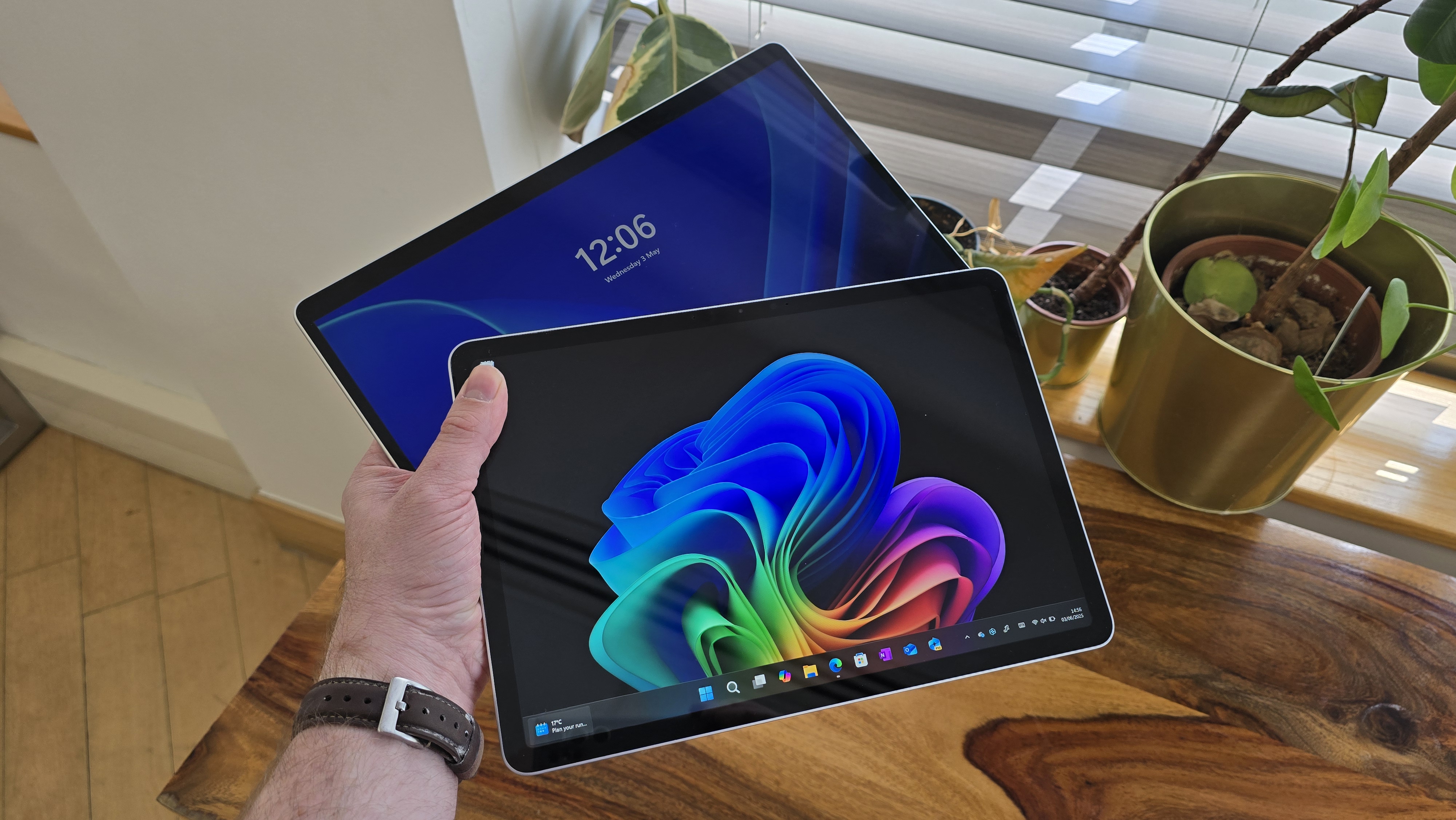 Microsoft Surface Pro 12 tablet on wooden table in relaxed cafe