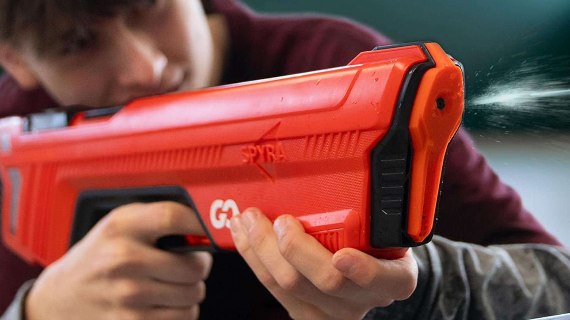 A boy fires the SpyraGo while aiming down the sights