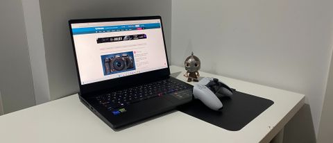 The MSI Vector GP66 with a Funko Pop and PS5 controller resting on a table