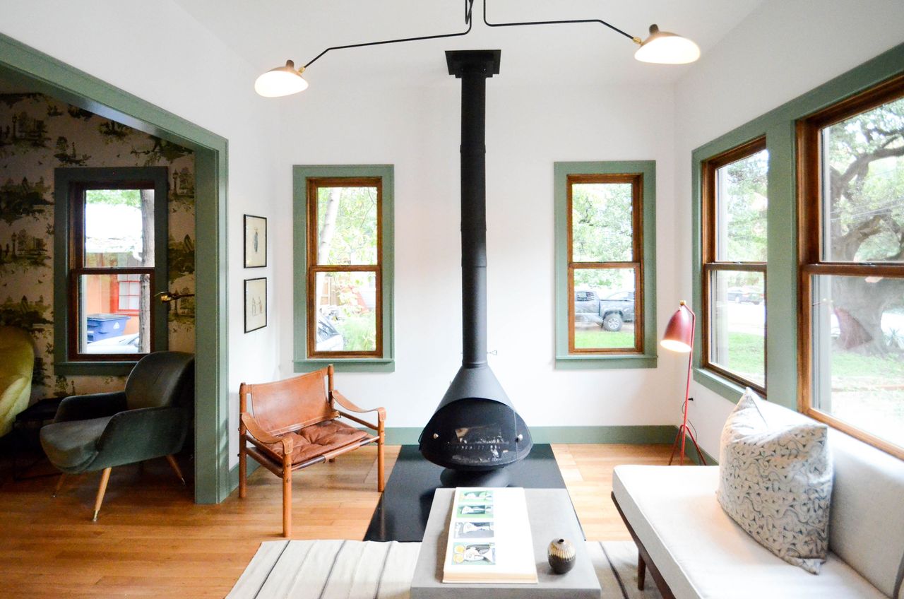 a retro inspired living room with painted boxes around the window