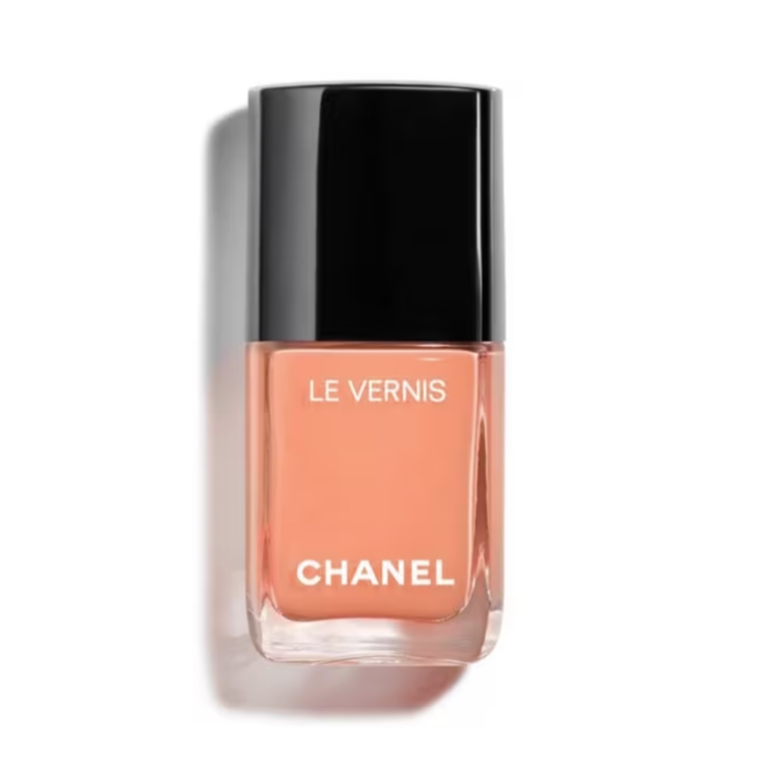 A product shot of CHANEL Le Vernis Nail Colour in shade 195 Poète (a pastel peach orange colour), on a white background