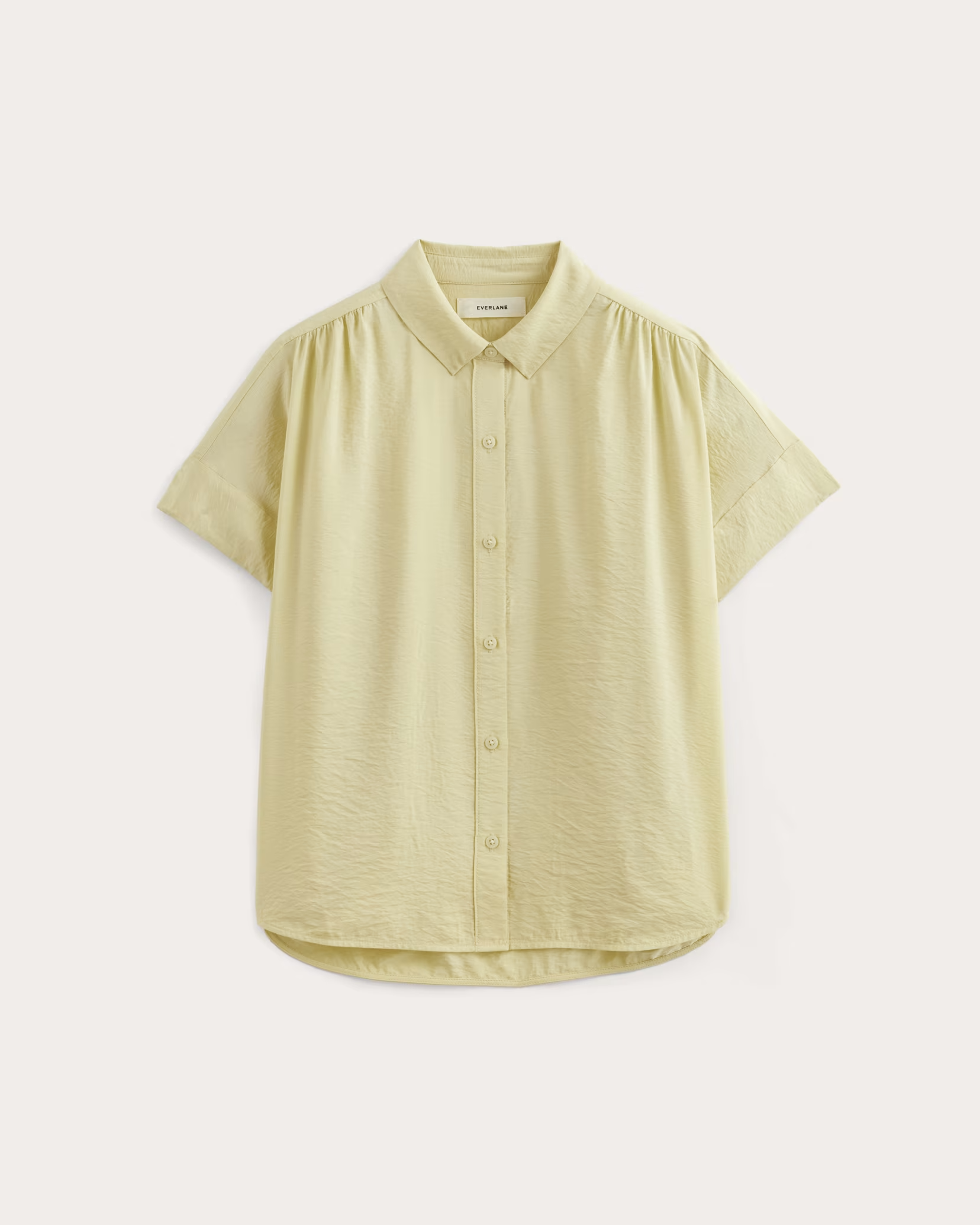 A yellow short sleeve button up shirt