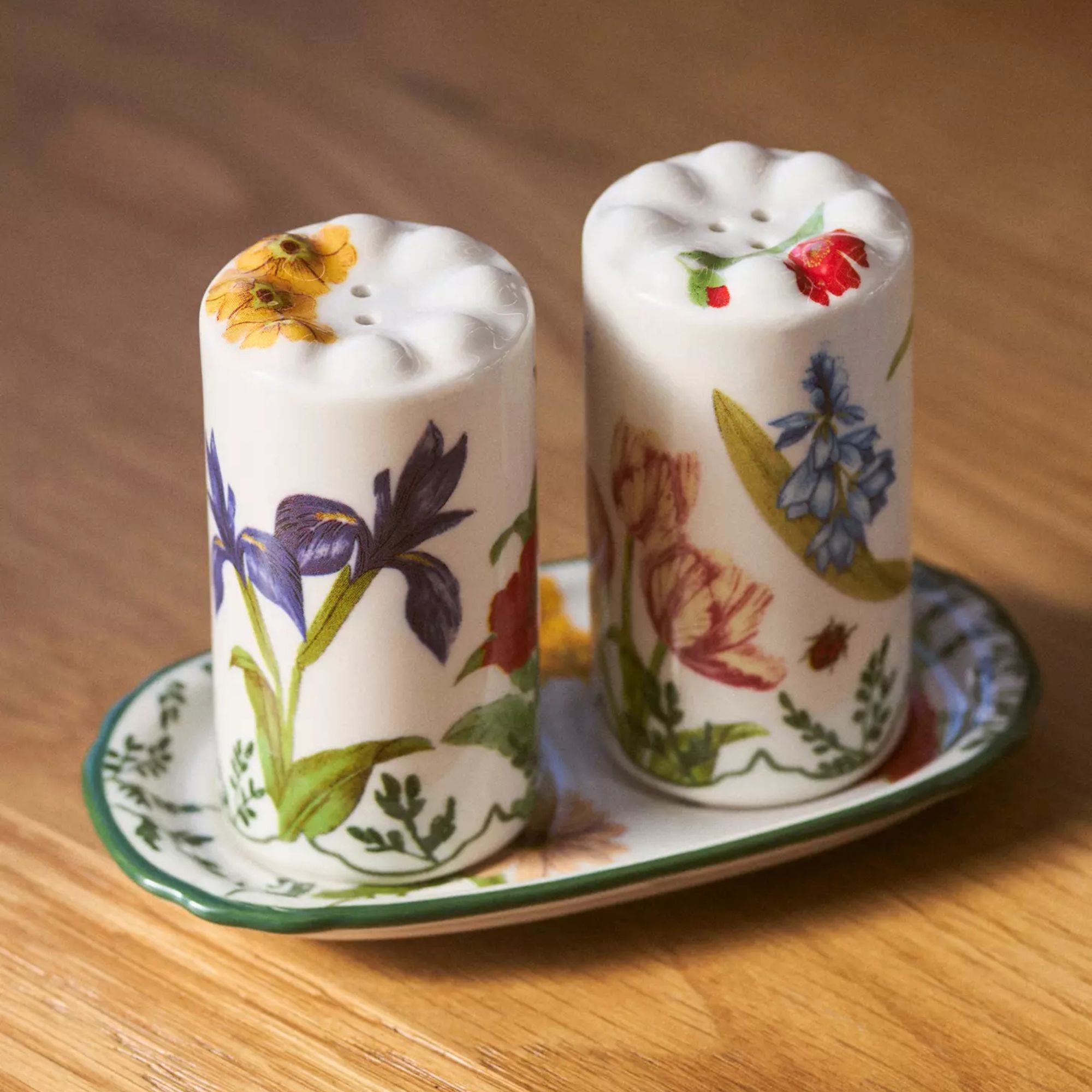 Floral ceramic salt and pepper shakers on matching tray
