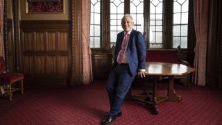 Former Speaker of the House John Bercow poses next to a desk in Parliament.