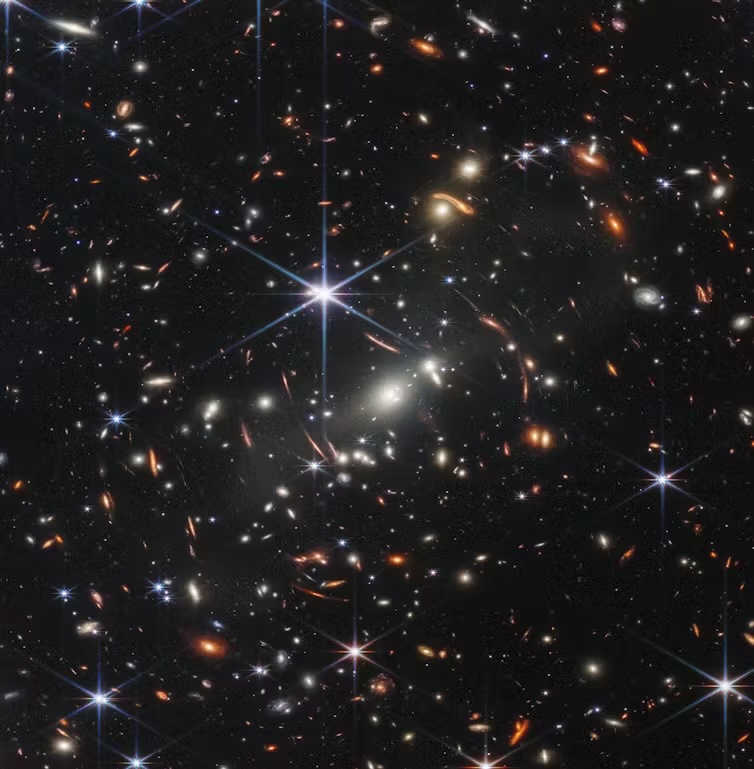 A JWST image showing many stars and distant galaxies