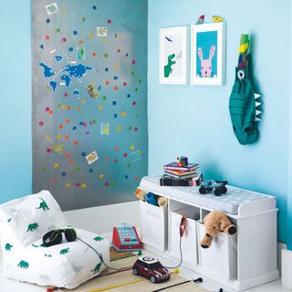 Children's room with a magnetic board on top of a blue wall