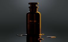 Louis Vuitton Pur Oud fragrance in black bottle against black background 