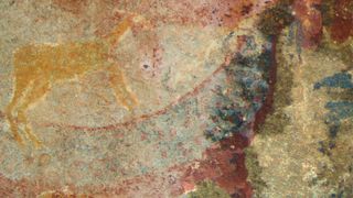 Cave painting showing a walrus-like tusked creature on a stone wall.