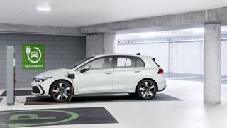 Volkswagen Golf GTE in a carpark at electric charging point