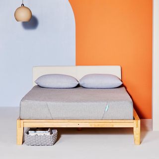 A Siena Mattress in a bright blue and orange bedroom