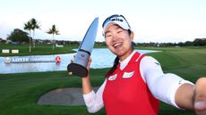 A Lim Kim takes a selfie with the 2024 Lotte Championship trophy after her two-stroke victory