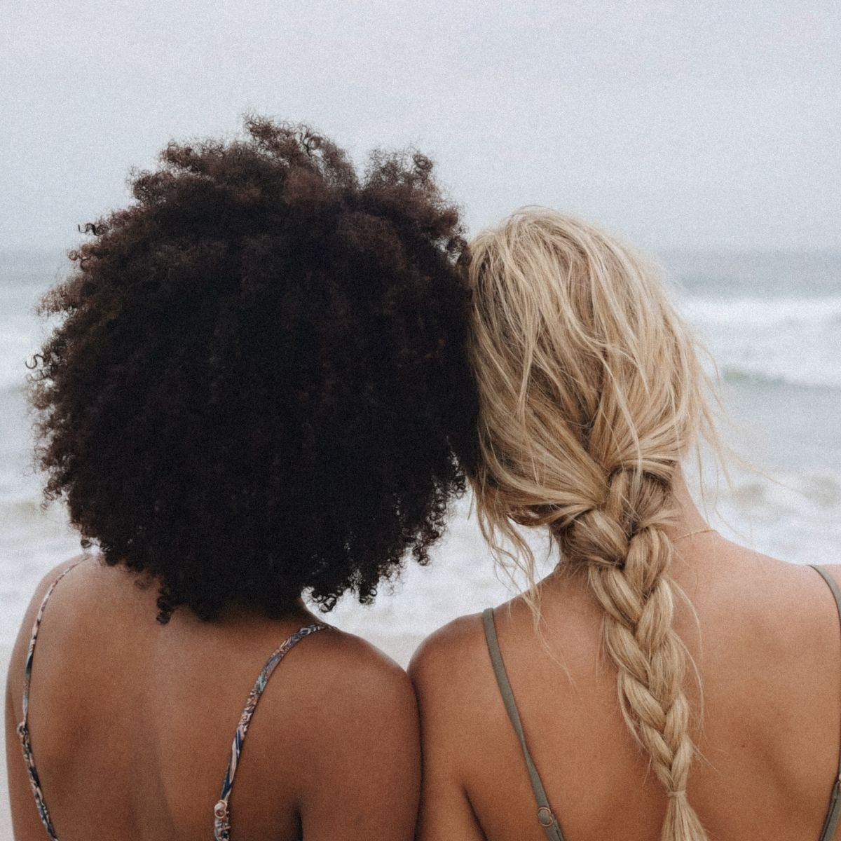 Two women at the beach, friends spending the day together