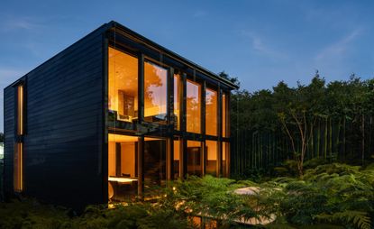 Steel prefab house in hero night shot