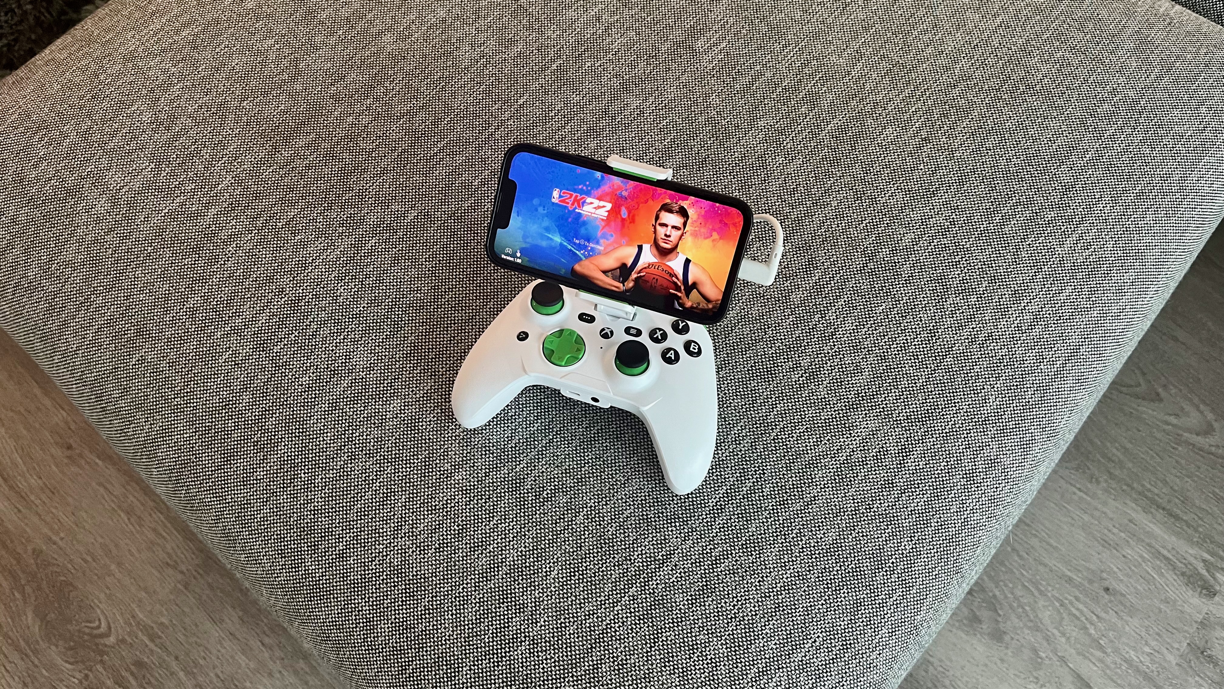 The RiotPWR Xbox Cloud Gaming Controller for iOS on a couch