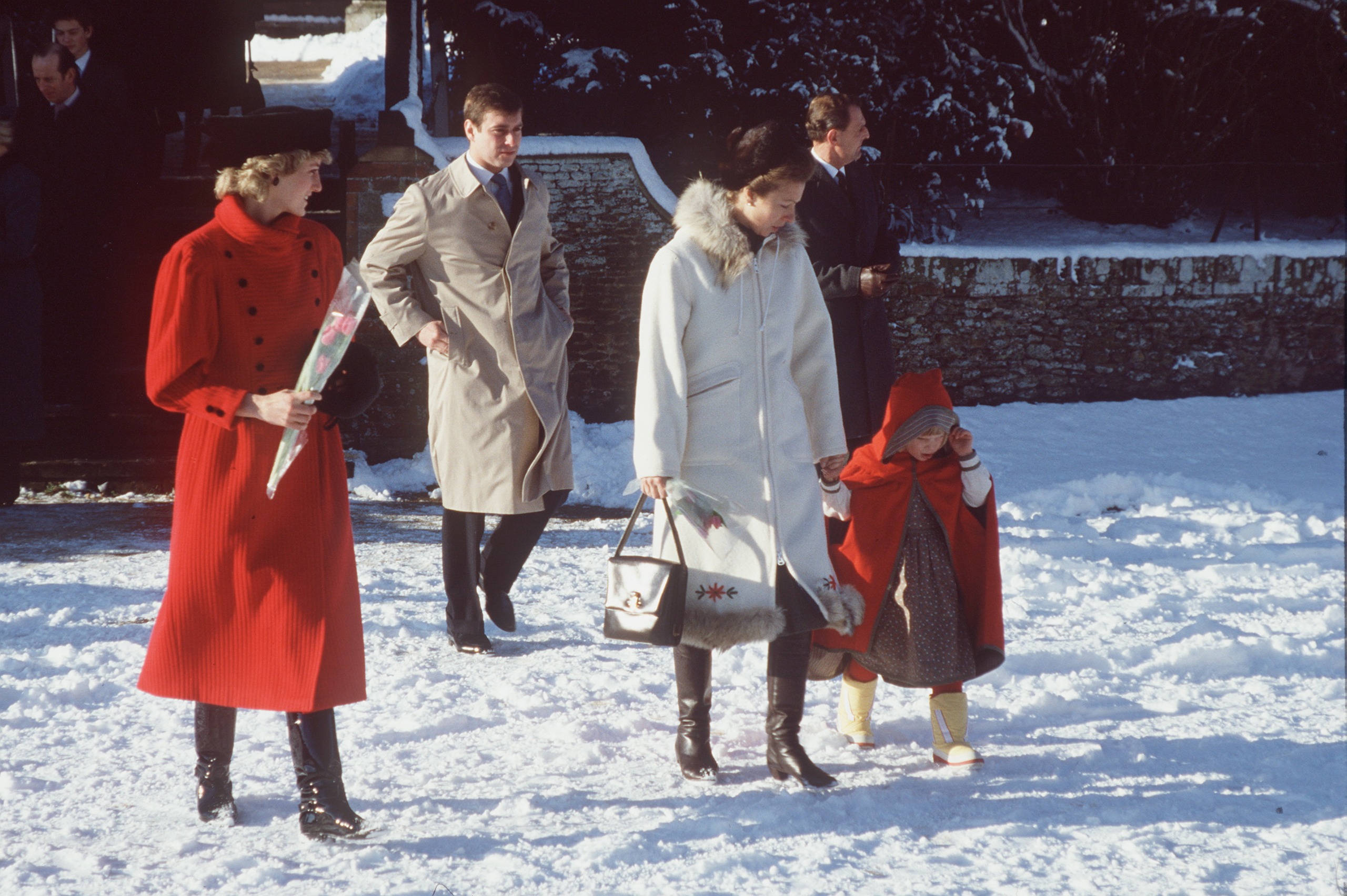 Princess Diana walking in the snow with Prince Andrew and Princess Anne