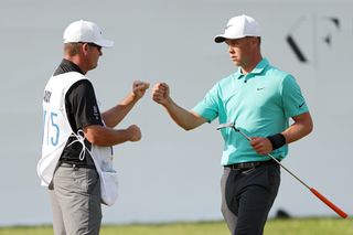 Hardy fist bumps with his caddie